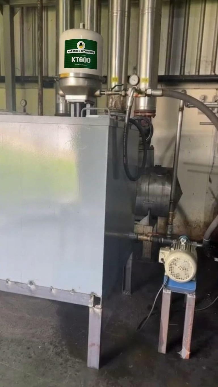 KT600 centrifuge filter mounted on a grey thermic oil tank with pump and motor in an industrial plant